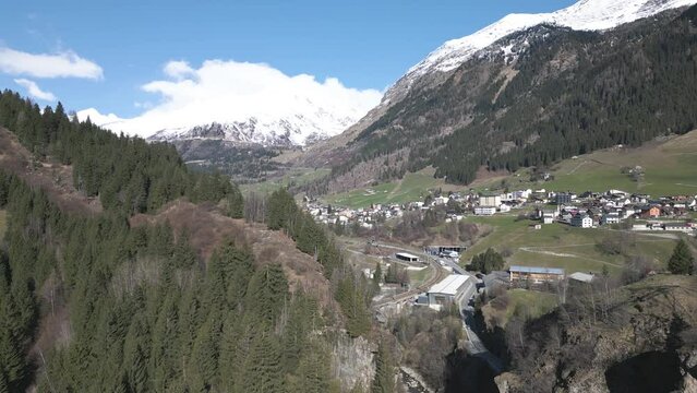 Airolo Municipality, Switzerland. Aerial View of Green Landscape and Village in Valley on Sunny Spring Day