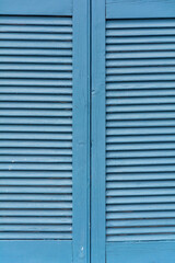 Closed blue wooden window shutters as a background texture