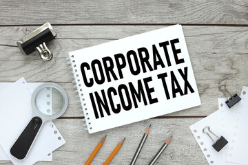 CIT corporate income tax symbol. Concept words CIT corporate income tax on white note on a beautiful wooden background. Business and CIT corporate income tax concept. Copy space.