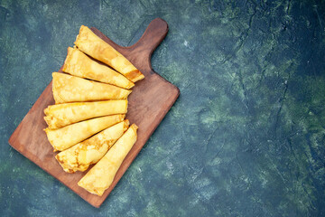 top view delicious pancakes rolled on a dark background hotcake dough pie meat color pastry sweet...