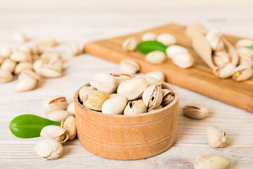 Fresh healthy Pistachios in bowl on colored table background. Top view Healthy eating concept. Super foods