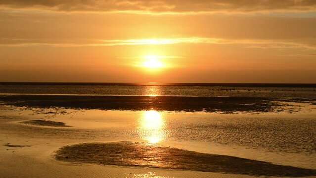 Colorful sunset at the beach of Schiermonnikoog island in the Dutch Waddensea region in the North of The Netherlands.