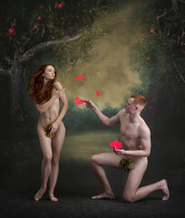 Handsome man, Adam holding red heart and gives to Eve in the garden of Eden over vintage style...