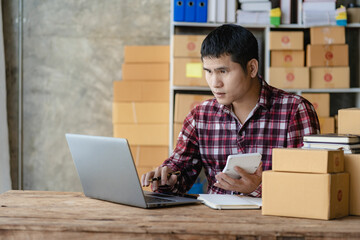 Asian man taking customer orders online with laptop, online business and e-commerce online store. sell home goods