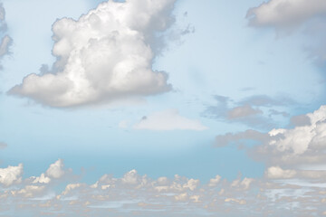 Small white fluffy clouds on the blue sky.