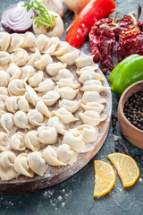 front view raw little dumplings with flour and vegetables on dark background meat dough food dish calorie color vegetable meal