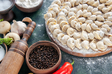 front view raw little dumplings with flour and vegetables on dark background meat dough food dish color vegetable meal