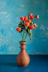 front view red withered flowers inside vase on blue background color tree flower photo rose beauty