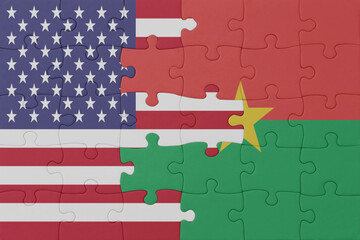 puzzle with the national flag of burkina faso and united states of america.macro