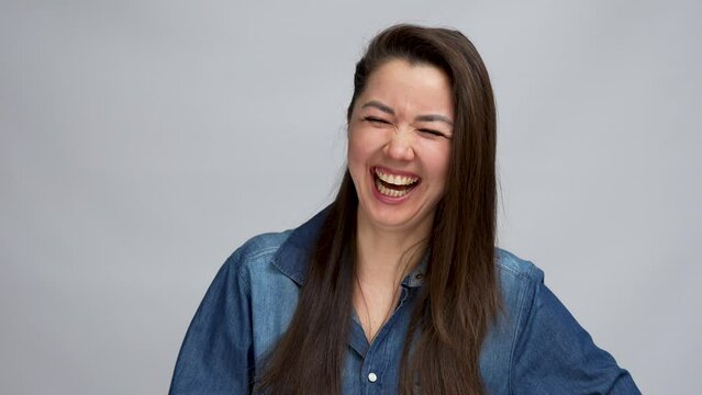 Laughing woman portrait over grey background
