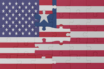 puzzle with the national flag of liberia and united states of america.macro