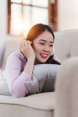 Attractive Asian woman resting comfortable living room and using mobile phone, Relax, Sofa, Lifestyle