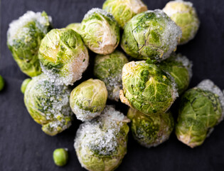 Frozen, fresh Brussels sprouts. Texture of frozen Brussels sprouts. Brussels sprouts top view. Horizontal photo.