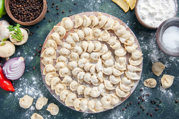 top view little raw dumplings with flour on a dark gray background dough color food food dish meat calorie meal