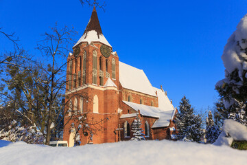 Fototapeta na wymiar Beautiful brick church in Pruszcz Gdanski at snowy winter, Poland