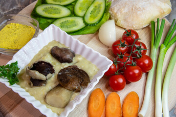 Soup with mushrooms and vegetables on the wooden table...boletus soup recipe...