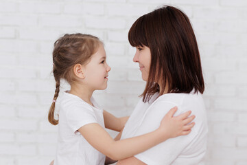 Portrait of mother and daughter in white t-shirts