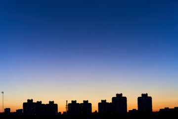 The silhouette of the city against the beautiful sky during sunset. Dense construction of buildings in Minsk