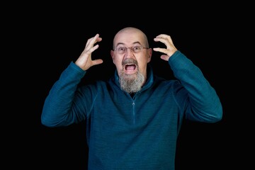Caucasian man yelling in a fit of despair, isolated on black background