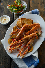 King prawns near sauce and salad
