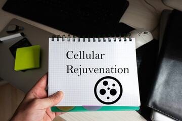 Cellular rejuvenation word on notebook holding man against desktop.
