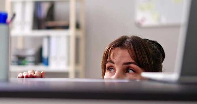 Scared Woman Hiding Behind Chair