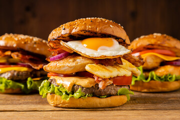 Mega beef and chicken burger with fried egg, bacon and grilled halloumi cheese.