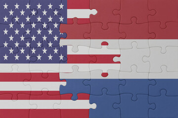 puzzle with the national flag of netherlands and united states of america. macro
