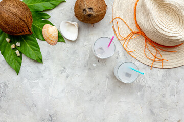 Fresh coconut milk cocktail in glasses with straw beach hat