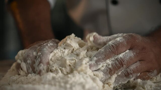 Professional Man making bread dough, closeup shot