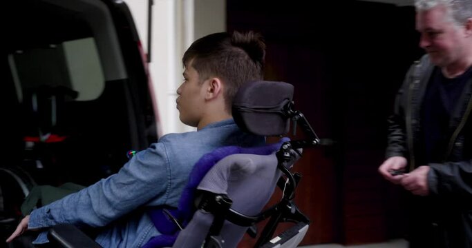 MS PAN WS Father assisting disabled son getting in van