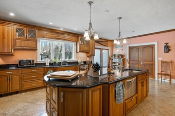 Modern and cozy kitchen with brown furniture, countertops with two doors