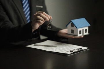 Real estate broker agent presenting and consult to customer to decision making sign insurance form agreement, buy and sell home model, concerning mortgage loan offer for and house insurance