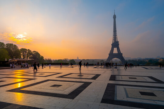Eiffel Tower, French: Tour Eiffel, silhouette at dawn. View from Trocadero Square with geometrical marble pavement. Paris, France - Powered by Adobe