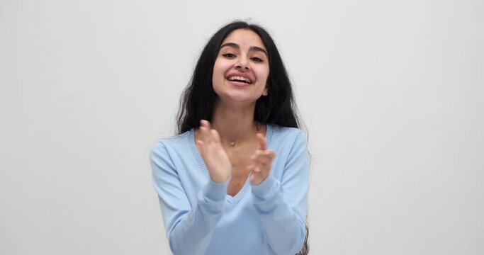Excited woman congratulating by clapping hands and cheering