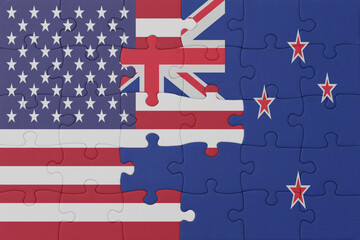 Naklejka premium puzzle with the national flag of new zealand and united states of america. macro
