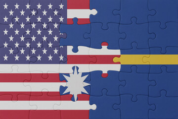 puzzle with the national flag of Nauru and united states of america. macro