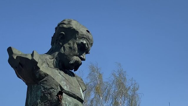 A monument to Taras Shevchenko in the city of Borodyanka, shot through with bullets. The monument mutilated by the Russians in Borodyanka. Sunny day. High quality 4k footage