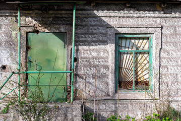 empty windows of a damaged house in Ukraine