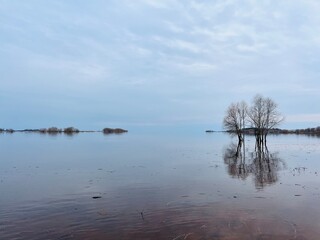 Sky reflection on the river surface, riverside, cloudy weather, natural river view