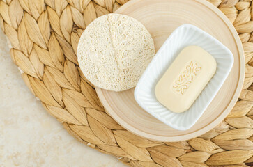 Bar of soap (solid shampoo) and loofah bath sponge. Eco friendly toiletries. Natural beauty treatment, skin care or zero waste concept. Top view, copy space.