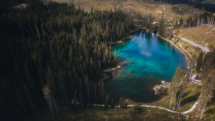  blue lake surrounded by trees in a mountain environment. drone aerial photography