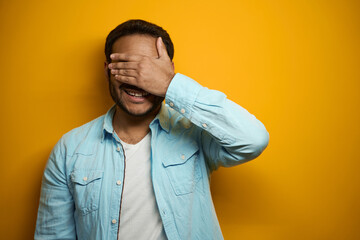 Portrait of Hindu smiling man closing eyes