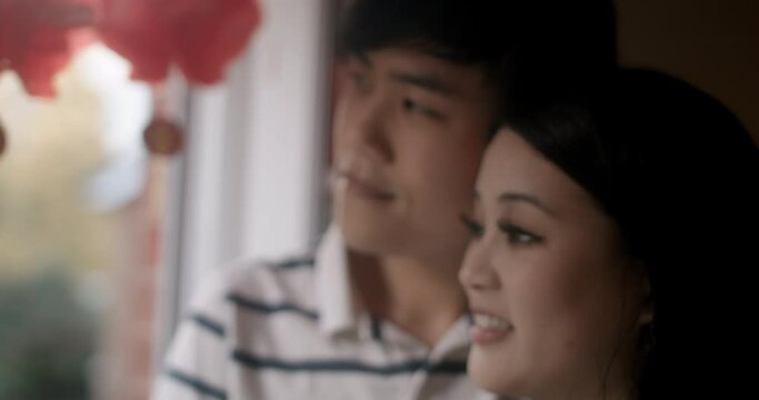 CU Smiling couple standing by Chinese lanterns