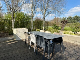 Appeltern, Netherlands, April 09, 2023: The garden inspiration park for the whole family. Modern garden terrace. Garden table and chairs on the wooden platform