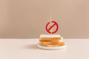 Gluten free bread on beige background with symbol crossed sprinkle. Gluten free concept.