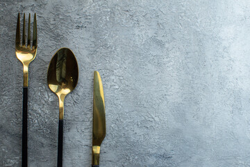 Elegant bright cutlery set on isolated gray background with free space