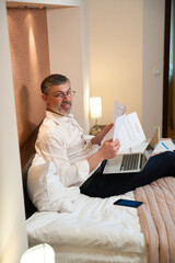 Man checking document, finishing work, looking at the camera