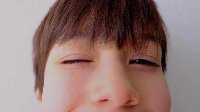 close-up of part of the child's face, boy 10-12 years old Asian-European appearance, human eye looking fun at the camera, the concept of surveillance, peeping, tracking