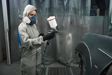 Concentrated woman working at garage service station
